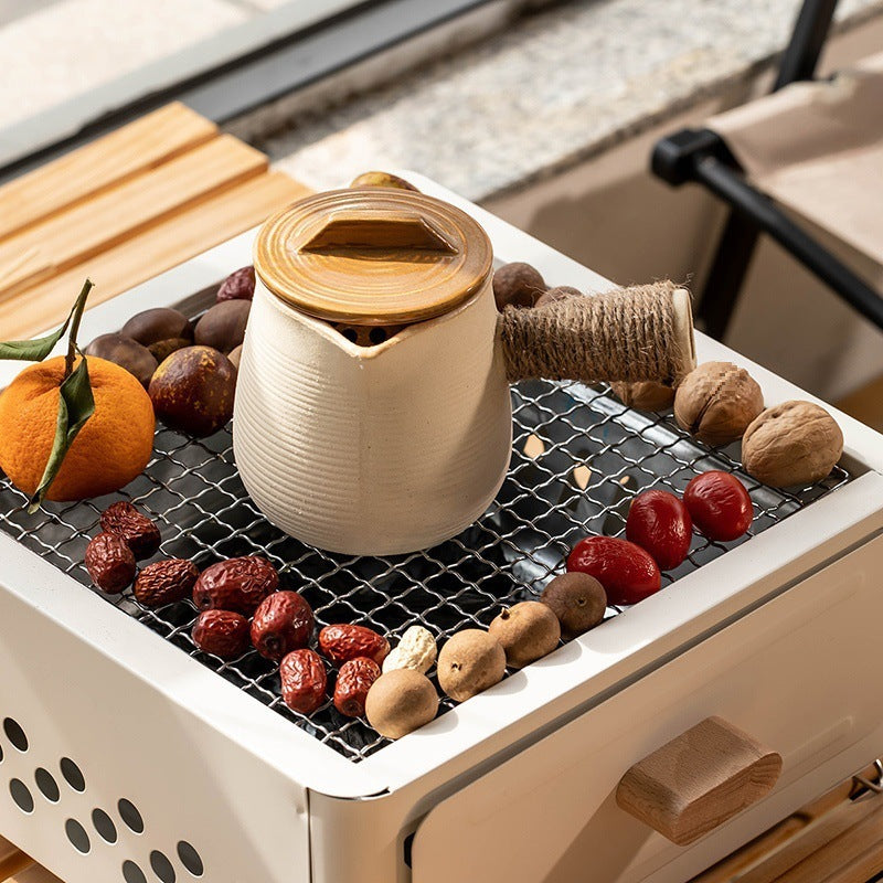 “Indoor BBQ box with grilling accessories and non-stick surface, perfect for cooking delicious meals indoors year-round, offering a smoke-free experience.”