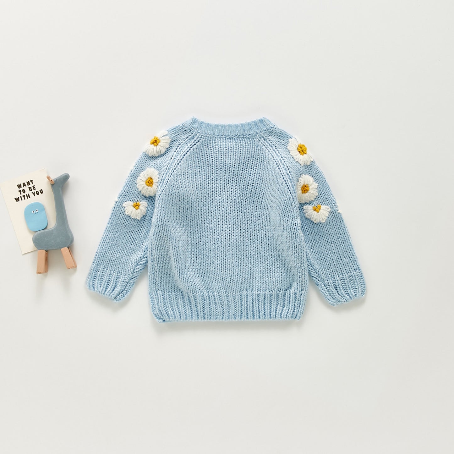 Polka dot baby girl sweater in soft pastel hues
