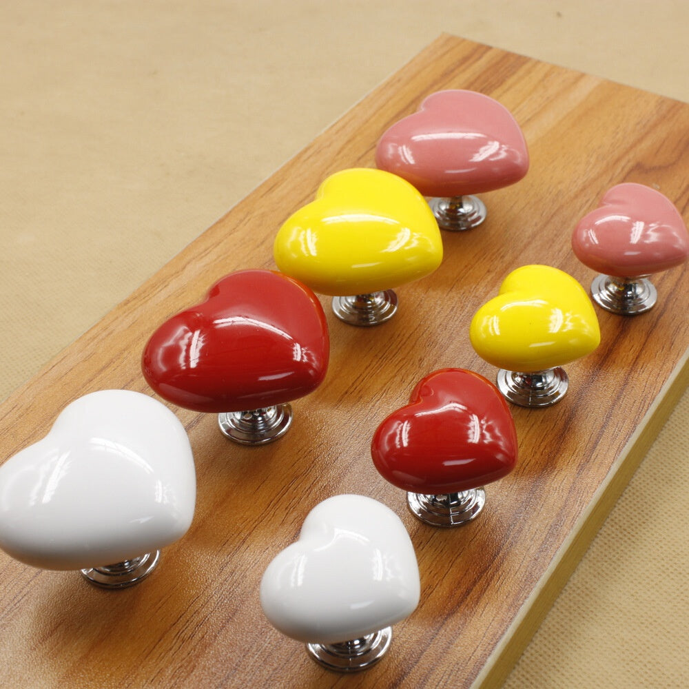 Heart-shaped Love Ceramic Handle for wardrobe drawers and cabinet doors, featuring a vibrant coloured glaze finish. Available in multiple sizes, this handle adds a unique and stylish touch to any home decor. Ideal for enhancing wardrobes, kitchen cabinets, and furniture. Durable and easy to install for a quick home upgrade. Perfect for those seeking a decorative yet functional addition to their space. Everything Amazing Shop for this product.