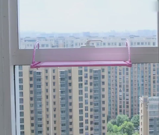 Adjustable Hanging Window Sill Drying Rack in modern home setting, holding clothes over balcony