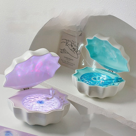Wireless Bluetooth Mini Shell Light Stereo Speaker with LED Wave Light, available in Jelly Sea, Star Moon White, and Aurora Purple colors. Perfect for desktop, home, and outdoor use.