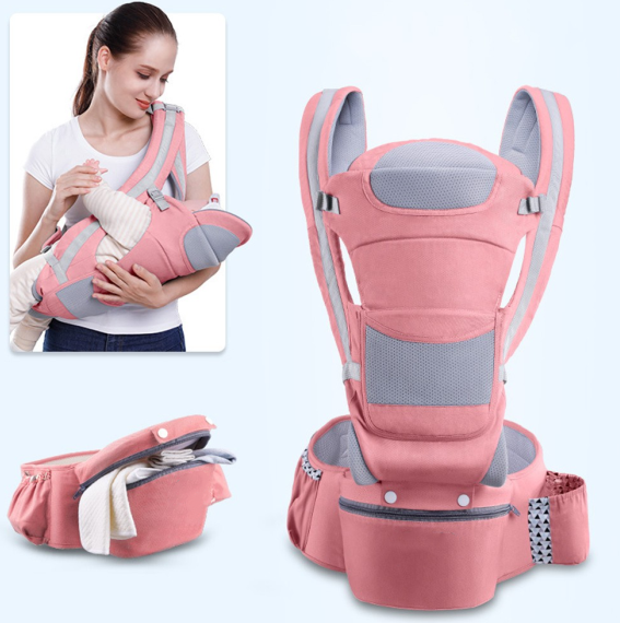 Baby smiling in hip carrier