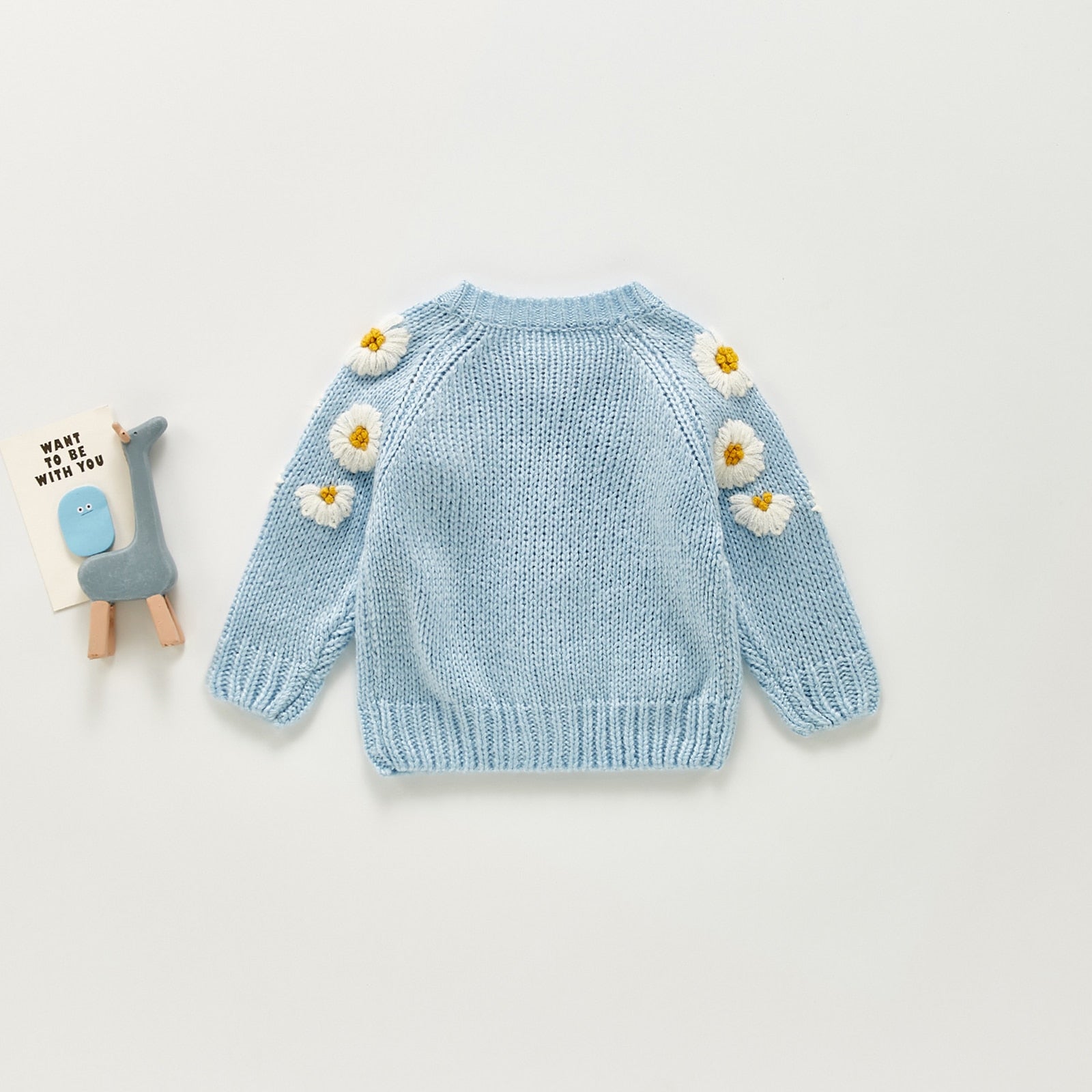 Polka dot baby girl sweater in soft pastel hues