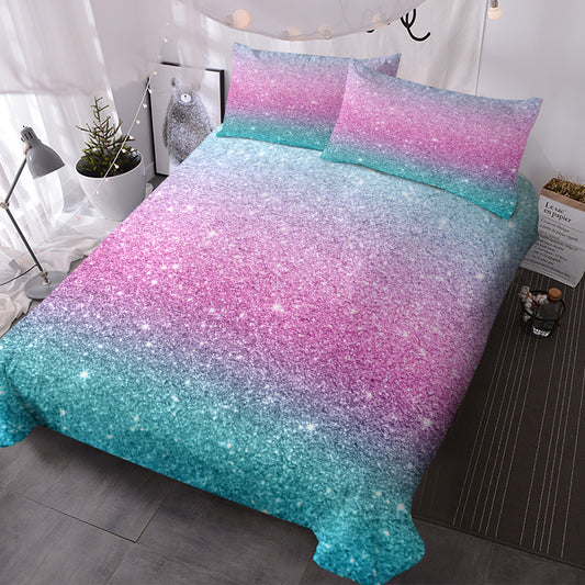 Pastel rainbow glitter ombre duvet cover set in purple blue and green with two matching pillow shams on a single bed.
