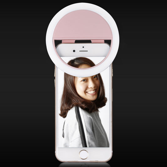 RK-12 USB rechargeable selfie fill light clipped onto a mobile phone, featuring bright LED illumination and compact design, ideal for selfies, vlogging, and nighttime photography.